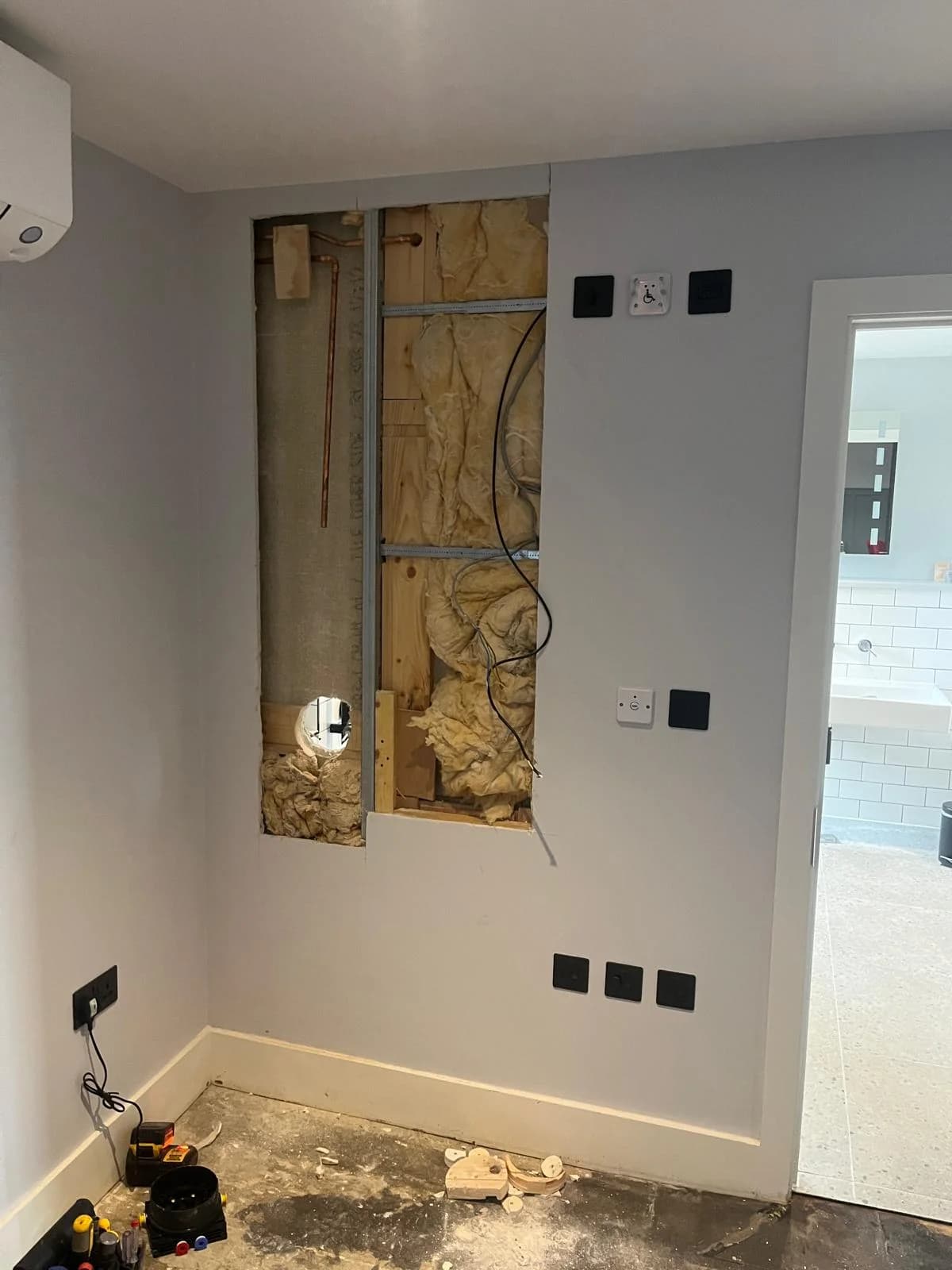 Electrical wiring outside a bathroom before remedial work