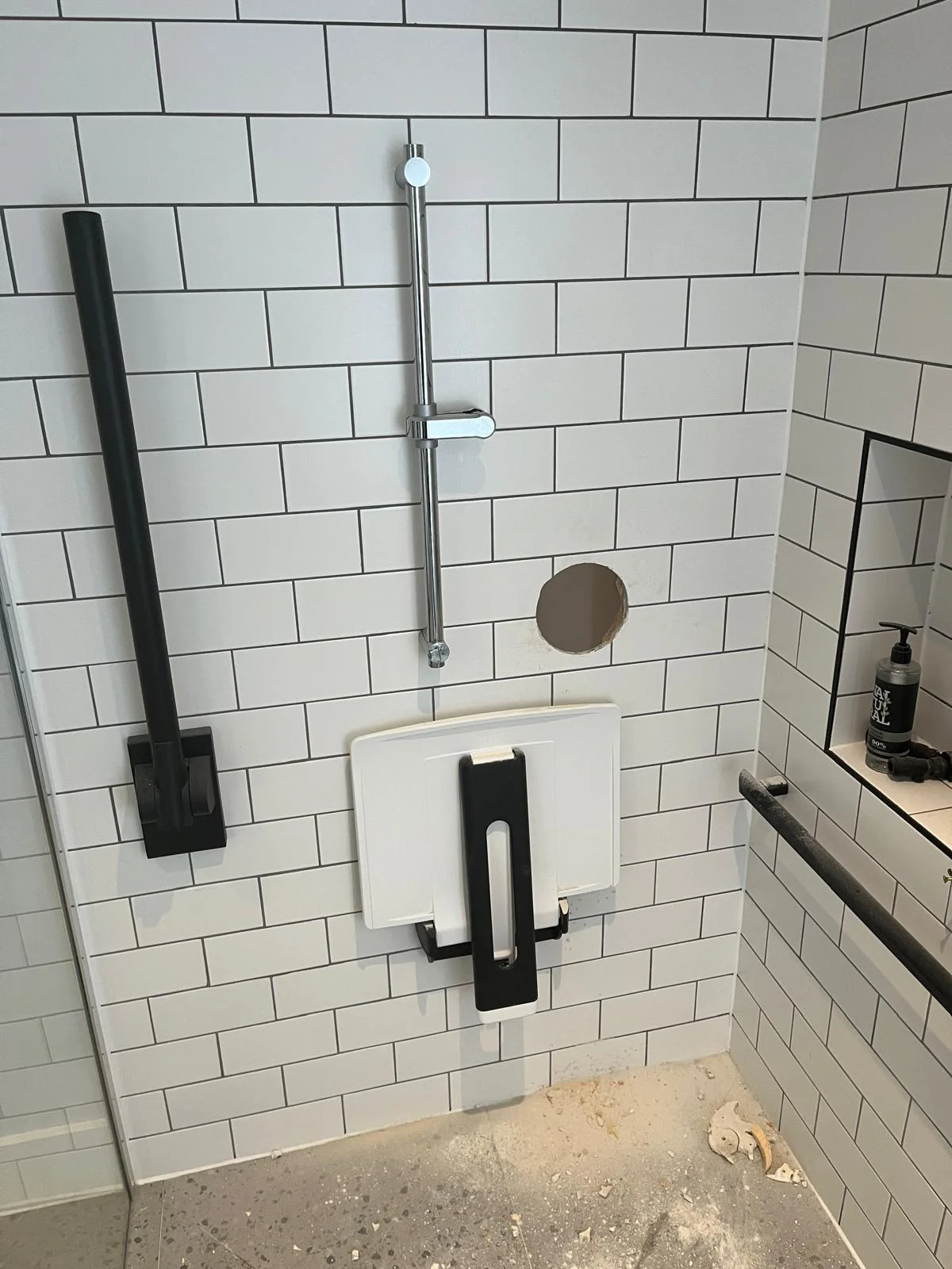 Support rails installed around an accessible shower area