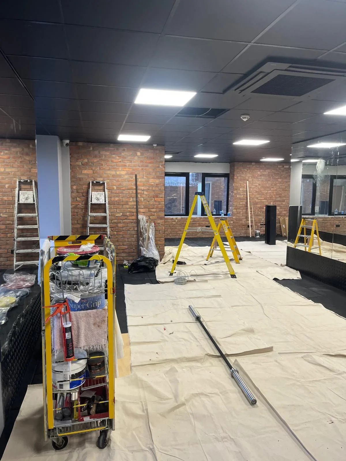 Brick-walled room with refurbishment works in progress