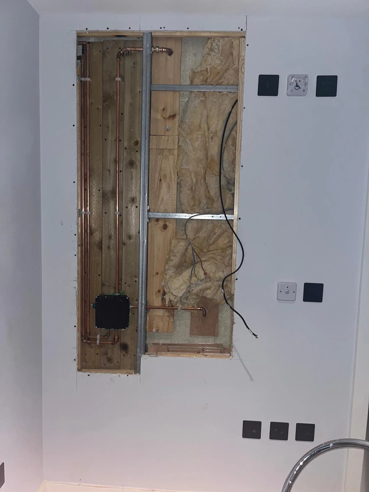 Bathroom wall opened for new shower valve installation