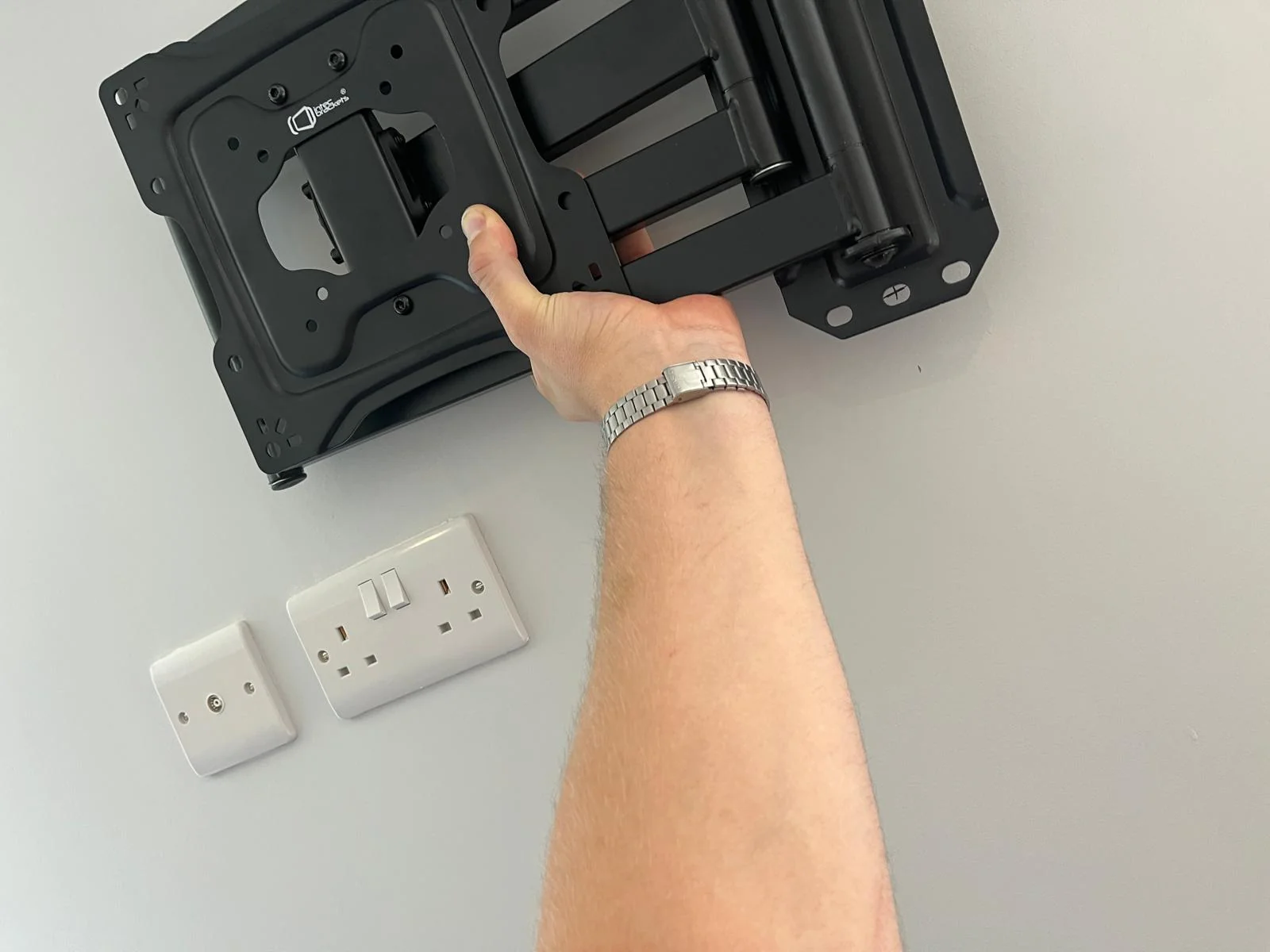 Television bracket being secured during wall-mount installation