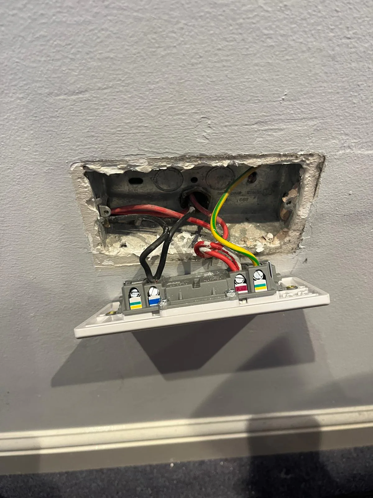 Existing socket wiring and terminal connections exposed during replacement